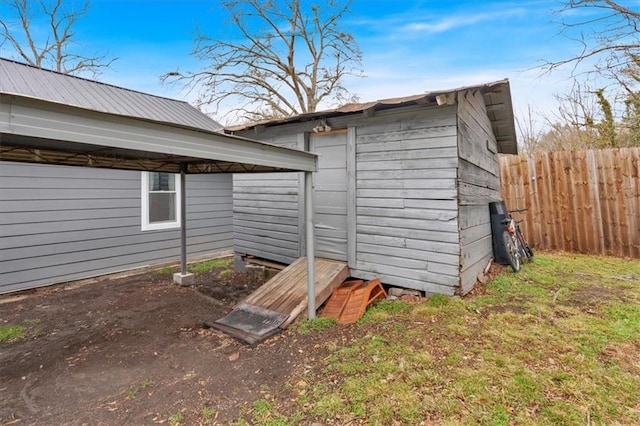 view of shed featuring fence