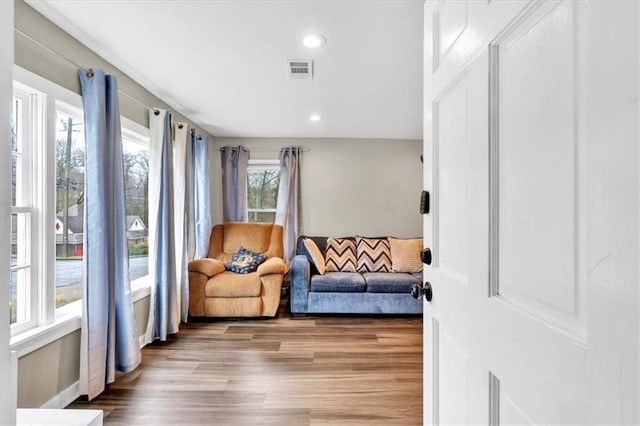 sitting room with recessed lighting, visible vents, and wood finished floors