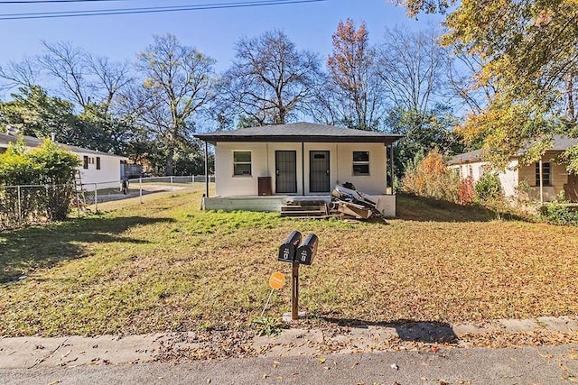 view of front of home with covered porch and a front yard