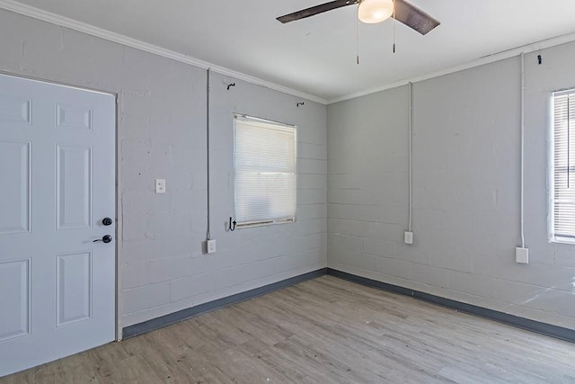 unfurnished room featuring ceiling fan, light wood-type flooring, and crown molding