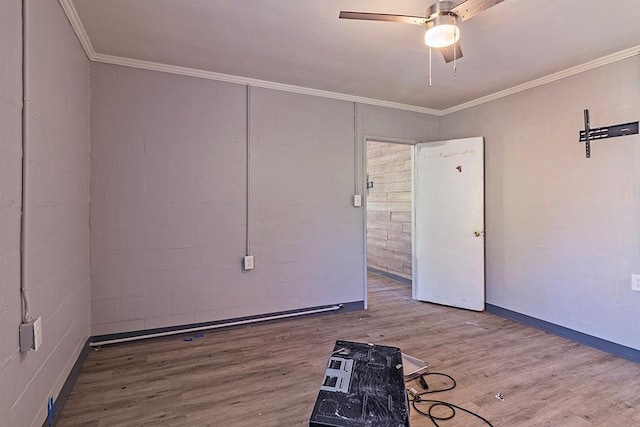 empty room featuring ceiling fan, wood-type flooring, and crown molding