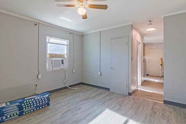 spare room with ceiling fan, cooling unit, ornamental molding, and light hardwood / wood-style flooring