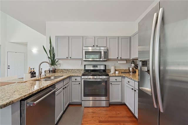 350 Eagle Tiff Dr, Sugar Hill, GA 30518 - kitchen with stainless steel appliances, gray cabinets, wood finished floors, and light stone countertops