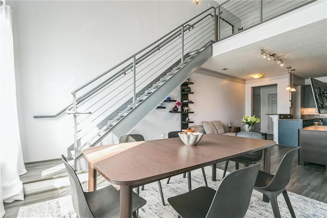 dining area with light hardwood / wood-style floors and ornamental molding