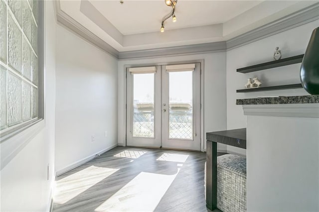 entryway with light hardwood / wood-style floors, french doors, and track lighting