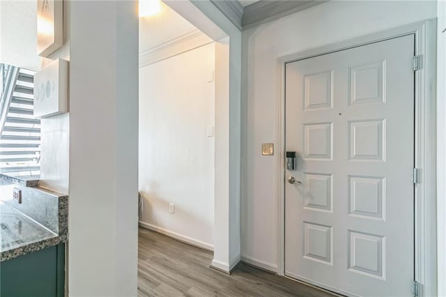 entrance foyer featuring crown molding and wood-type flooring