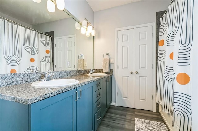 bathroom featuring vanity, hardwood / wood-style floors, and a shower with curtain