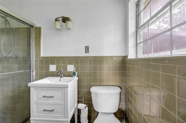 14300 Veterans Memorial Hwy, Villa Rica, GA 30180 - bathroom featuring tile walls, plenty of natural light, vanity, toilet, and a shower with door