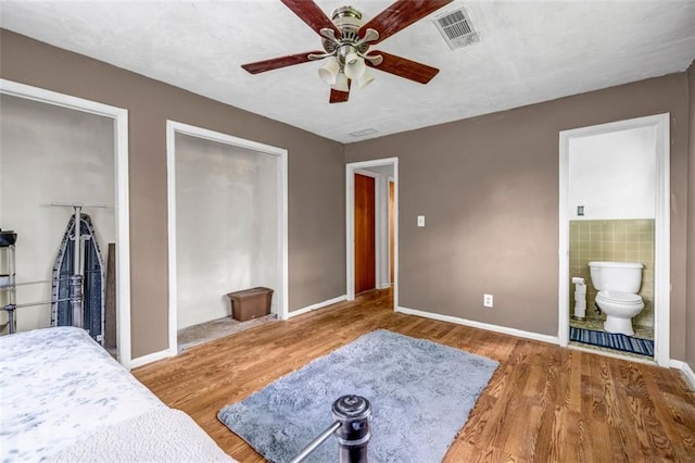 14300 Veterans Memorial Hwy, Villa Rica, GA 30180 - bedroom with two closets, wood finished floors, baseboards, and ensuite bathroom