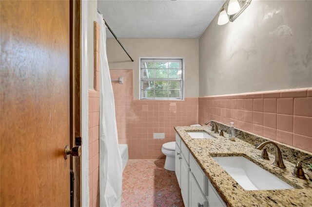 14300 Veterans Memorial Hwy, Villa Rica, GA 30180 - bathroom with toilet, double vanity, tile walls, shower / bath combo, and a wainscoted wall