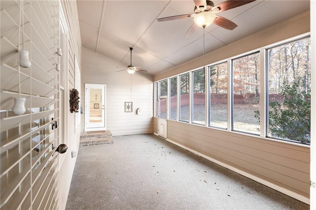 unfurnished sunroom featuring ceiling fan, a healthy amount of sunlight, and lofted ceiling