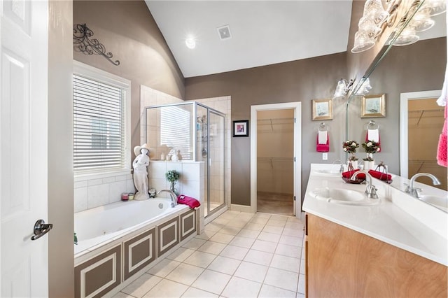 bathroom with tile patterned flooring, vanity, separate shower and tub, and lofted ceiling