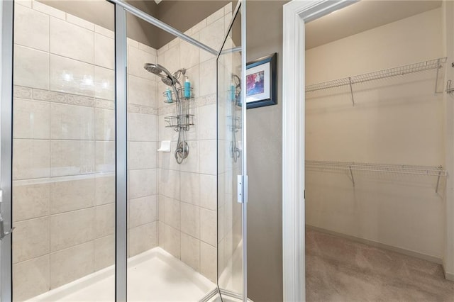 bathroom featuring a shower with shower door