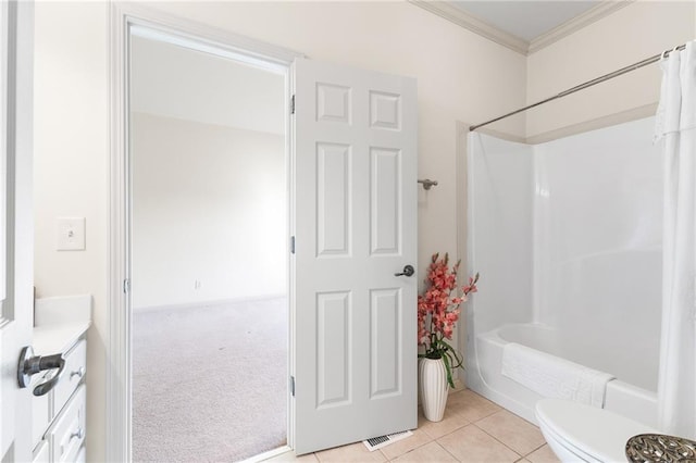 full bathroom with tile patterned floors, crown molding, toilet, vanity, and shower / tub combo