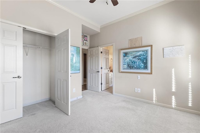 unfurnished bedroom featuring ceiling fan, ornamental molding, light carpet, and a closet