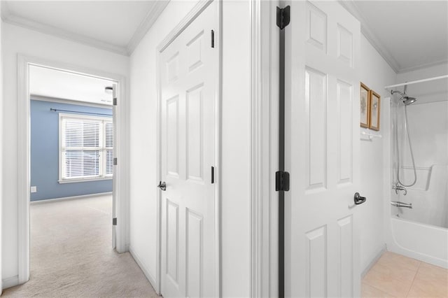 hall featuring light colored carpet and crown molding