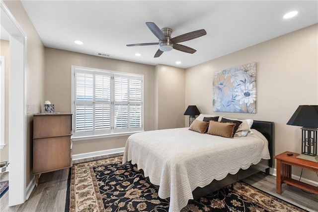 bedroom with hardwood / wood-style floors and ceiling fan