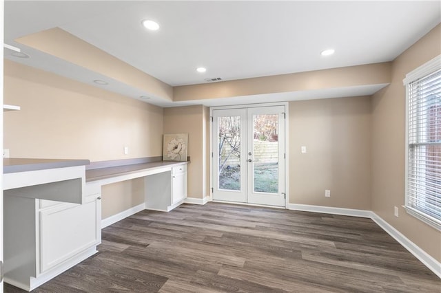 interior space featuring french doors, built in desk, and dark wood-type flooring