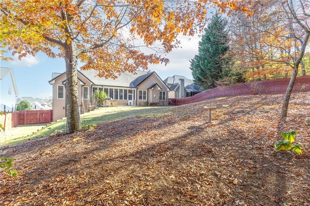 back of property featuring a sunroom