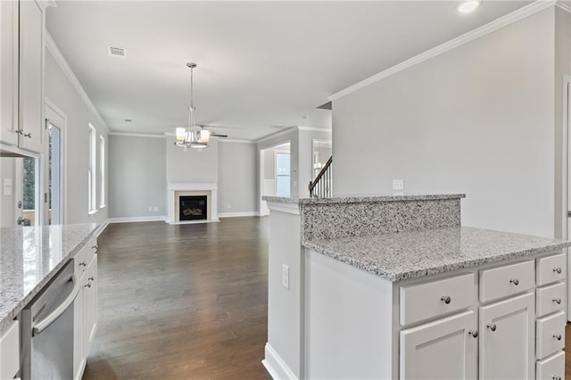 kitchen featuring white cabinetry, light stone countertops, decorative light fixtures, and stainless steel dishwasher