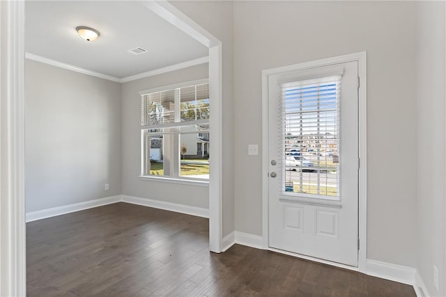 entrance foyer with ornamental molding, dark hardwood / wood-style floors, and a healthy amount of sunlight