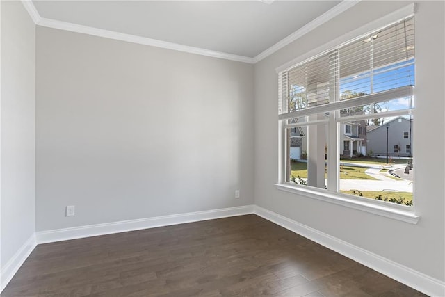 empty room with a wealth of natural light, ornamental molding, and dark hardwood / wood-style floors