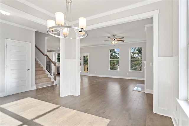 unfurnished living room featuring crown molding, dark wood-type flooring, and ceiling fan with notable chandelier