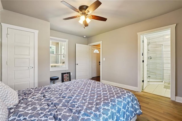 bedroom with ceiling fan, wood-type flooring, and connected bathroom