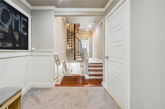 interior space with ornamental molding and light carpet