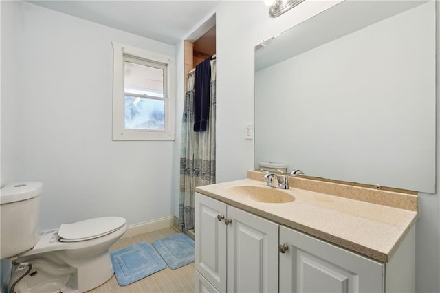 bathroom with toilet, vanity, tile patterned floors, and walk in shower