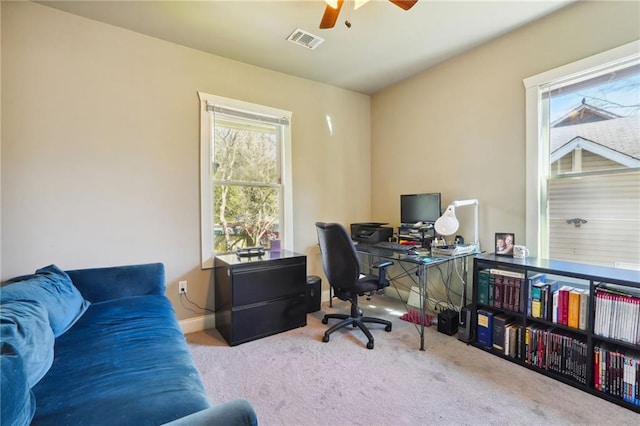 carpeted office featuring ceiling fan