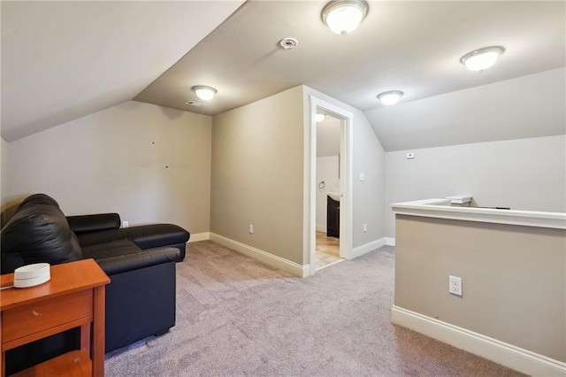 living room featuring light carpet and vaulted ceiling