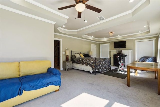 bedroom with ceiling fan, carpet flooring, ornamental molding, and a raised ceiling