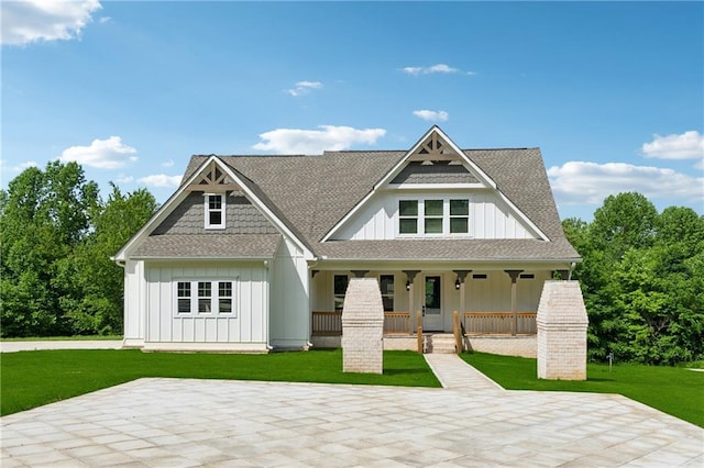 1656 Talking Rock Rd, Jasper, GA 30143 - view of front facade featuring board and batten siding, a porch, a front lawn, and a shingled roof