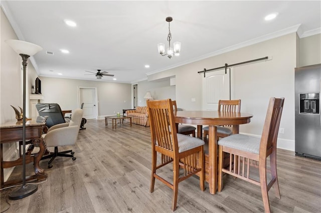 1656 Talking Rock Rd, Jasper, GA 30143 - dining space featuring a barn door, a ceiling fan, light wood-style floors, recessed lighting, and crown molding