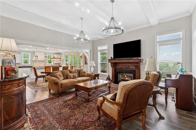 1656 Talking Rock Rd, Jasper, GA 30143 - living room featuring dark wood-style flooring, a lit fireplace, beamed ceiling, a chandelier, and ornamental molding