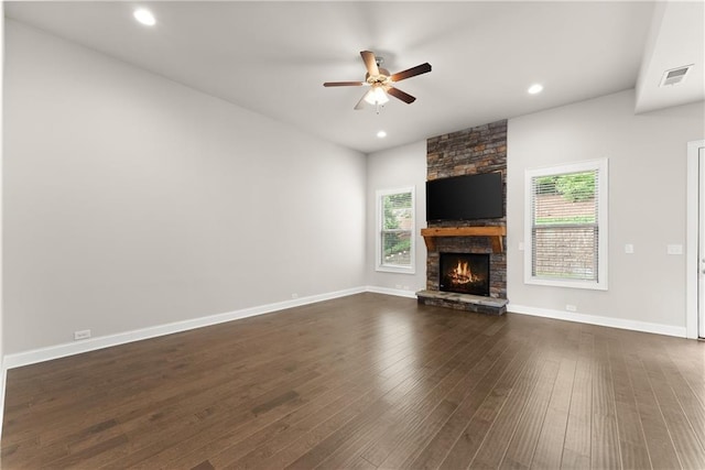 427 Dawson Pointe Pkwy, Dawsonville, GA 30534 - unfurnished living room with ceiling fan, a stone fireplace, dark wood-style flooring, baseboards, and recessed lighting