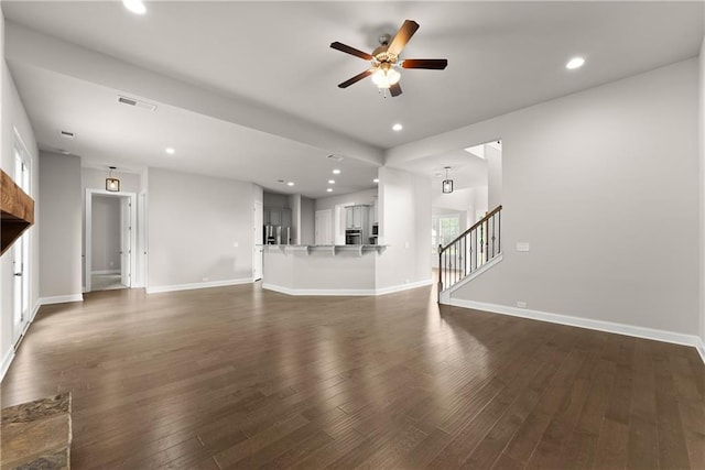 427 Dawson Pointe Pkwy, Dawsonville, GA 30534 - unfurnished living room featuring a ceiling fan, stairs, dark wood-style floors, recessed lighting, and baseboards
