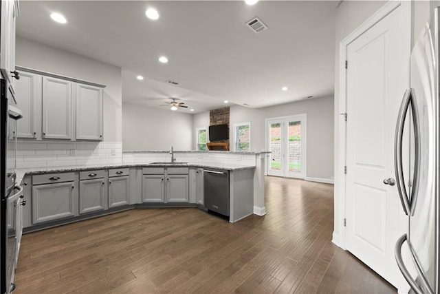 427 Dawson Pointe Pkwy, Dawsonville, GA 30534 - kitchen featuring dishwashing machine, stainless steel refrigerator, gray cabinetry, a peninsula, and a sink