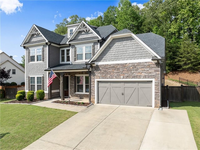 427 Dawson Pointe Pkwy, Dawsonville, GA 30534 - craftsman-style home with stone siding, concrete driveway, covered porch, an attached garage, and roof with shingles