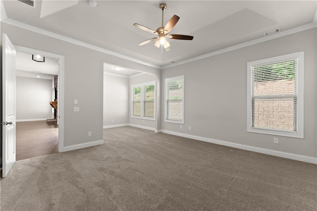 427 Dawson Pointe Pkwy, Dawsonville, GA 30534 - carpeted empty room with a ceiling fan, crown molding, healthy amount of natural light, baseboards, and a tray ceiling