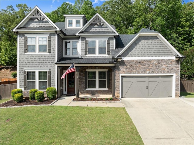 427 Dawson Pointe Pkwy, Dawsonville, GA 30534 - craftsman house featuring roof with shingles, driveway, stone siding, and an attached garage