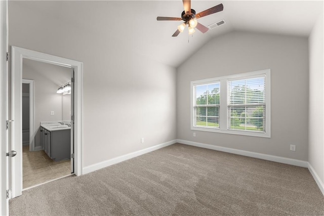 427 Dawson Pointe Pkwy, Dawsonville, GA 30534 - unfurnished bedroom with light colored carpet, vaulted ceiling, baseboards, ensuite bathroom, and a ceiling fan