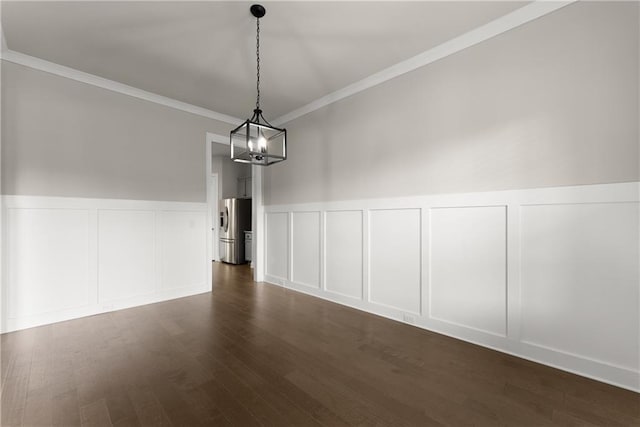 427 Dawson Pointe Pkwy, Dawsonville, GA 30534 - unfurnished dining area with a decorative wall, dark wood-style flooring, crown molding, a chandelier, and wainscoting