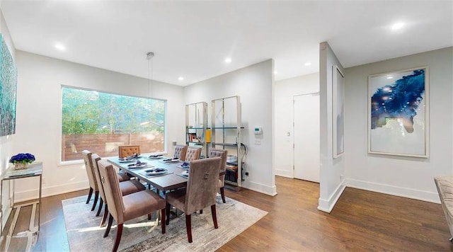 dining space featuring recessed lighting, wood finished floors, and baseboards