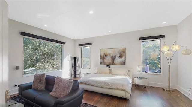 bedroom with recessed lighting, wood finished floors, and baseboards