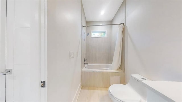 bathroom featuring tile patterned flooring, toilet, and shower / bathtub combination