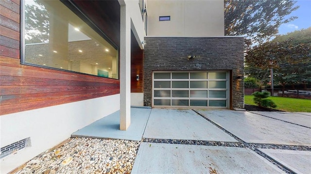 view of home's exterior featuring a garage and stone siding