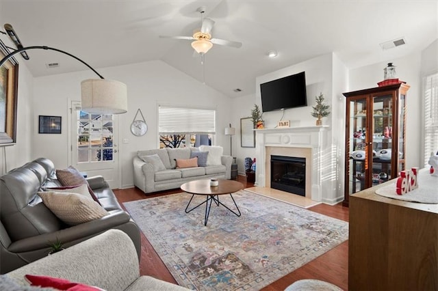 living room featuring ceiling fan, wood-type flooring, and lofted ceiling