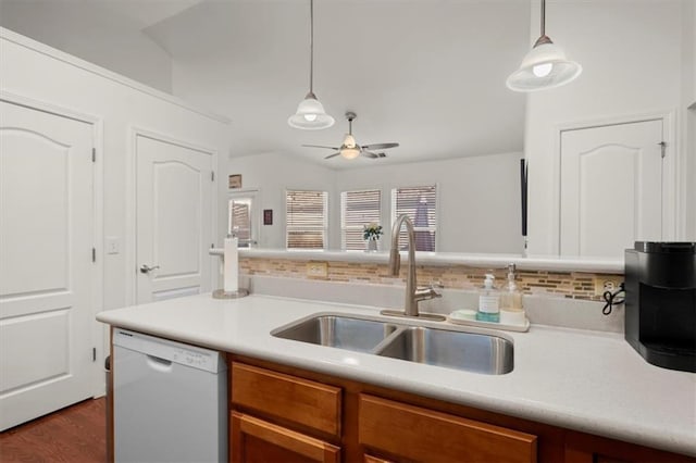 kitchen featuring ceiling fan, sink, dark wood-type flooring, white dishwasher, and decorative light fixtures